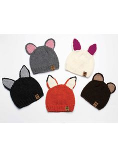 four knitted hats with ears and ears on them, all in different colors or sizes