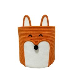 an orange and white fox shaped storage basket with eyes closed on the front, it has a black nose