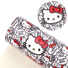 two hello kitty stickers are on top of a roll of toilet paper with red bows