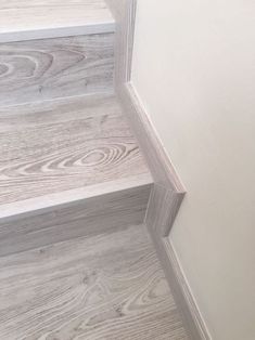 the bottom part of a white painted stair case