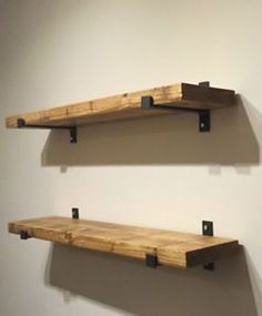 two wooden shelves mounted to the side of a wall