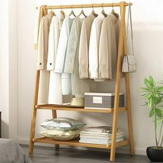 Discover the ultimate wardrobe organizer: our Bamboo Foldable Clothing Shelf. Made from sustainable bamboo, this stylish shelf effortlessly declutters your space while adding a touch of natural elegance. Perfect for small spaces or walk-in closets, its foldable design offers convenient storage without compromising style. Elevate your organization and embrace eco-friendly living with our Bamboo Foldable Clothing Shelf today. Features Sustainable Bamboo Construction: Durable and eco-friendly, our Portable Clothes Rack, Wood Shoe Storage, Cheap Flooring, Hall Stand, Wooden Bedroom, Scandinavian Color, Clothes Rail, Hall Tree, Garment Racks