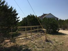 a wooden fence in front of a house