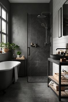 a black and white bathroom with a claw foot tub