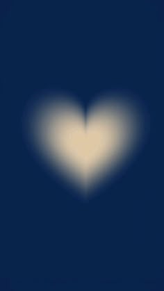 a white heart shaped object on a dark blue background with light coming from the center