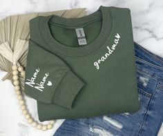 a green shirt with the words mama and baby on it next to some other items