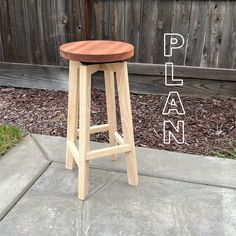 a wooden stool sitting on top of a sidewalk