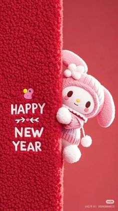 a stuffed animal hanging from the side of a red towel that says happy new year