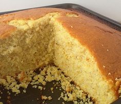 a cake that has been cut in half and is sitting on a pan with one slice taken out