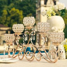 a table topped with lots of crystal candlesticks