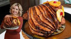 a woman holding a plate with some food on it