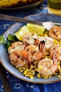 a plate with shrimp and corn on it