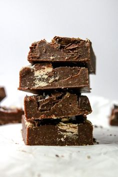 three pieces of brownie stacked on top of each other in front of a white background