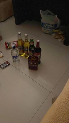 several bottles of alcohol are sitting on the floor