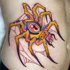 a woman's stomach with a colorful spider tattoo on it