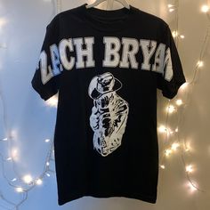 Brand New Never Worn Zach Bryan Buckeye Tee Size Small (Oversize Fit) Unisex Black Shirt/White Graphic Official Tour Merchandise 100% Cotton Only Flaw On This Is The Letters A, From Manufacturer. This Is From The First Run Of These T-Shirts. All Screen Printing Flaws Are As Shown In Photos* Pit To Pit 18 1/2” Baggy Shirts, Concert Tees, Oversized Fits, Black Shirt, Womens Tops, Tops & Tees, Black And White, Women Shopping, T Shirt