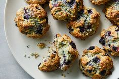 blueberry muffins on a white plate ready to be eaten