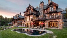 a large house with a pool in front of it and lots of windows on the side