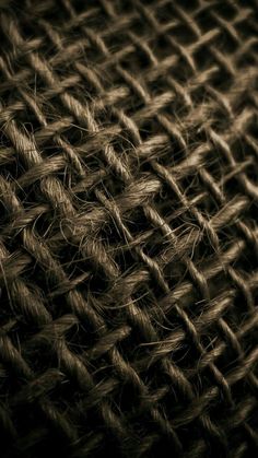 the texture of an old woven cloth is shown in black and brown tones, as well as some other things