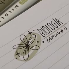 a close up of a notepad with writing on it and an image of a flower