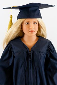 a doll wearing a graduation cap and gown is posed for a photo in front of a white background