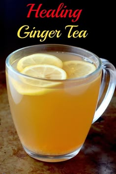 a glass mug filled with ginger tea and lemon slices