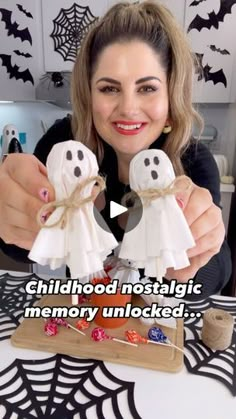 a woman holding two fake ghost figurines on top of a wooden board with the caption childhood nostalgic memory unlocked