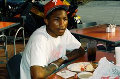 a man sitting at a table with food on it