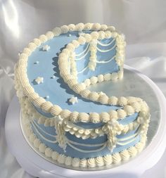 a blue and white cake sitting on top of a table