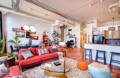 a living room filled with furniture and lots of windows