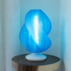 a blue lamp sitting on top of a wooden table