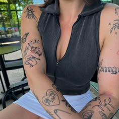 a woman with many tattoos on her arms