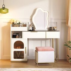 a dressing table with a mirror, stool and other items on it in a room