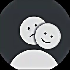 two white buttons with faces drawn on them in the middle of a black and white circle