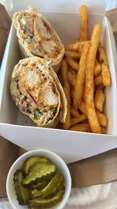 a sandwich and some french fries in a box