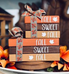 a stack of books with fall decorations on top and the words fall sweet written on them