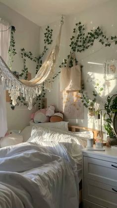 a bedroom with white walls and plants hanging from the ceiling