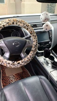 the interior of a car with leopard print steering wheel cover