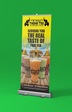 a sign advertising the real taste of thai tea in front of a green screen background