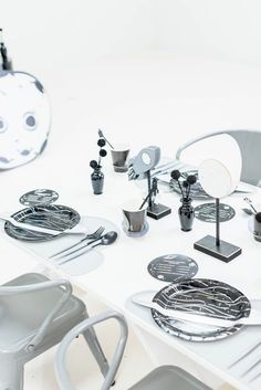 the table is set with silverware and other items on it, including plates and spoons