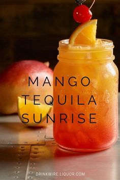 mango tequila sunrise in a mason jar with a cherry on top