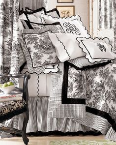 an image of a bed with black and white bedspreads on the coverlet