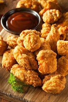 fried food on a cutting board with dipping sauce