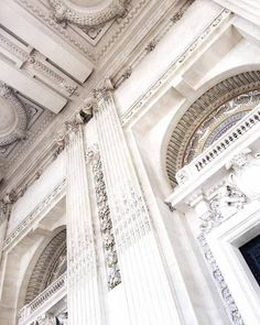 an ornate white building with two clocks on it's sides