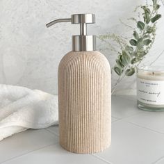 a soap dispenser sitting on top of a white counter