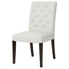 a white upholstered chair with dark wood legs and buttons on the backrest