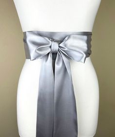 "Bright Silver Sash, Silver Satin Sash  Silver Obi Wrap Belt  Long Silver Sash Belt  Wedding Accessories  Silver Wedding Sash  Satin Swank  Make this Satin Swank® reversible waist sash the perfect finishing touch for your wedding, bridesmaid, or special occasion dress, or just the right piece to add instant polish to your dress or top.  This extra long version is 3.5 inches wide, 120 inches long, and will wrap around most waist sizes two times with a generous length remaining to tie in a bow or a simple knot with long-hanging tails.  Tie in front or in back.   Those with smaller waists may be able to wrap this extra-long sash around three times.  Position the waist wrap up high (just under the bustline) for a flattering, empire-waist effect. Luxury charmeuse satin in bright silver on both Silver Fitted Sash For Party, Fitted Silver Sash For Party, Wedding Sash With Tie Back, Wedding Sashes With Satin Finish, Elegant Satin Sash With Tie Back, Satin Ribbon Bridal Belt For Parties, Elegant Bridal Belt With Satin Bow For Bridesmaid, Wedding Bridal Belt With Sashes In Satin, Silver Bridal Belt With Sashes For Formal Occasion