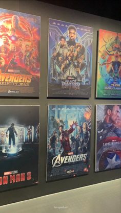 the avengers movie posters are hanging up on the wall