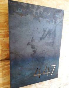 a metal plaque with the number four on it