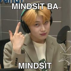 a young man wearing headphones sitting in front of a microphone with the words mindset on it